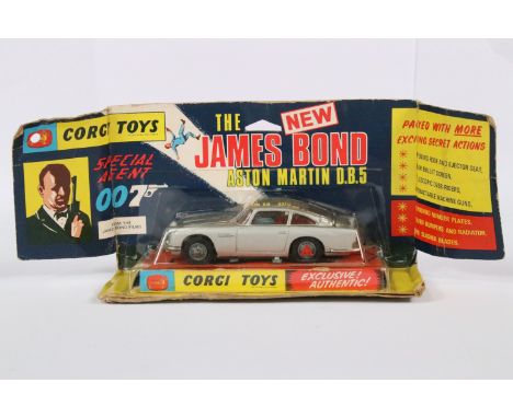Boxed / carded Corgi 270 The James Bond 007 Aston Martin diecast model with red tyre slashers and ejector figure, diecast ex,