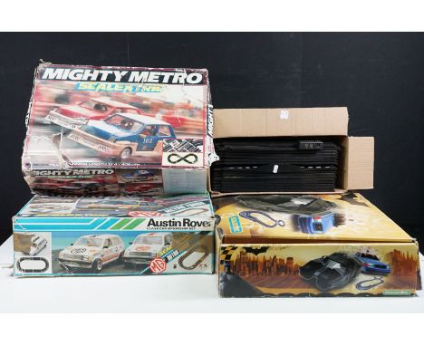 Three boxed Scalextric sets to include Batman Begins, Mighty Metro and MG Metro Turbo, all complete with relevant slot cars, 