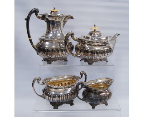 Silver four-piece tea set of part fluted boat shape with gadrooned and foliate borders and similar paw feet, by Walker &amp; 