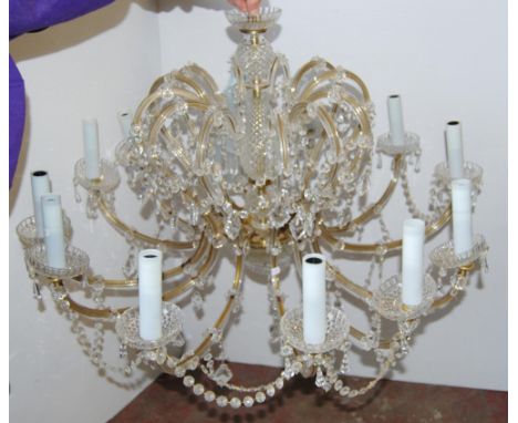 Venetian-style glass chandelier with twelve scroll branches, decorated with pans, garlands and drops, approximately 60cm high