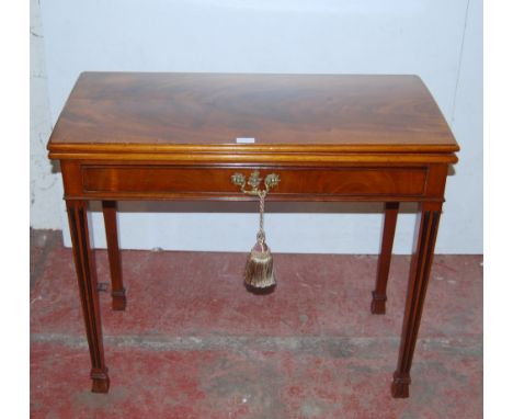 George III style mahogany fold-over card table, the top enclosing a later green felt-lined interior above a single drawer, on