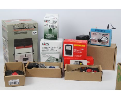 Hornby - Bachmann - Kato. A selection of 9 boxed Power Packs and Speed Regulators appearing in Excellent condition to include