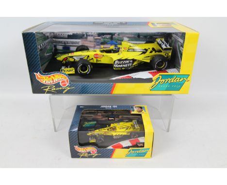 Hot Wheels - 2 x boxed models of Damon Hill's Jordan 199 in 1:43 # 22811 and 1:18 scale # 22822. Both models appear Mint, the