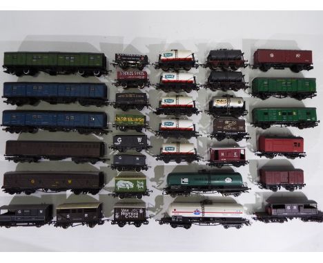 Hornby - Bachmann - Mainline - Lima - 33 x items of OO gauge rolling stock including 5 x St Ivel tankers, open wagons and gua