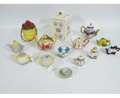 A lot of mostly ceramic doll's crockery to include teapots and a cup. Doll's crockery appears in excellent condition. (This d