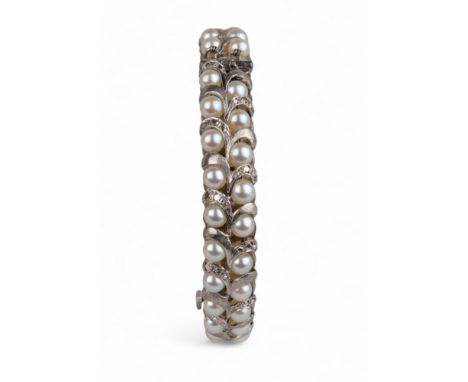 Indian, circa 1960s A cultured pearl and silver coloured metal bangle
