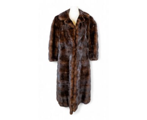 A vintage brown mink fur coat&nbsp;with three-quarter length sleeves, lined in red silk