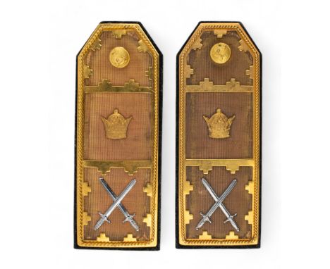 Iranian, 1950s A pair of gilded and silver metal epaulettes with the crown and cross swords motif, and Pahlavi lion button. T