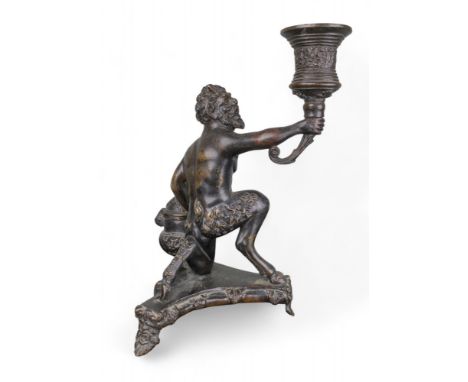 Italian 16th century and later A bronze inkstand in the form of a kneeling satyr holding a torch. The stand, inkwell and torc