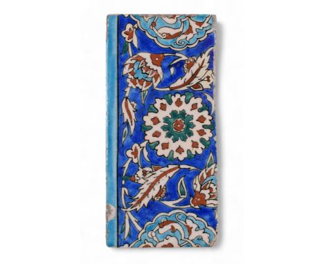 17th century An Iznik pottery tile Of a rectangular form, decorated on a cobalt-blue ground with a floral design  Dimensions: