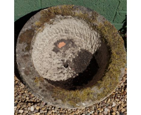A circular sandstone trough with hewn centre, 58cm diameter