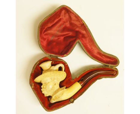 A Victorian Meerschaum carved pipe, the bowl finely carved as a Moor's head, wearing feather trimmed straw hat, the velvet an