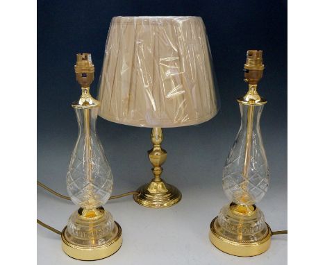 Two table lamps with star cut glass bodies; together with one other brass table lamp (3)