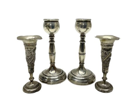 Pair of silver candlesticks, each upon knopped stem and weighted base, hallmarked, together with a pair of white metal vases,