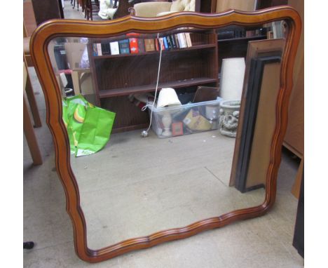 A shaped wall mirror together with a pair of Lowry prints and another print