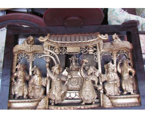 A Chinese carved panel depicting figures in an interior together with a nest of tables, CD rack and an occasional table with 