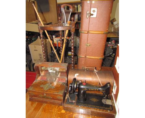 An oak tantalus with hinged compartments and a base drawer together with a Singer sewing machine, trunk, corner umbrella stan