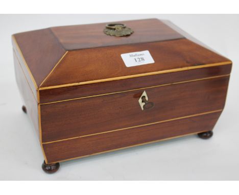 A GEORGE III MAHOGANY SATINWOOD INLAID TEA CADDY with brass ring handle and four turned feet 26cm wide 