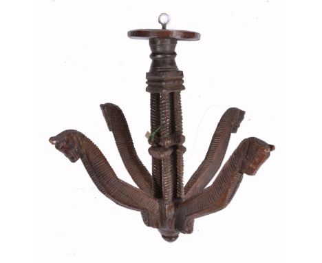 A GUJARATI CARVED WOODEN CLOTHES HANGER, a central cluster column support with four shaped arms each with carved horses head 