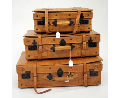 A GRADUATED SET OF THREE LIGHT BROWN LEATHER SUITCASES, the largest 68cm wide 