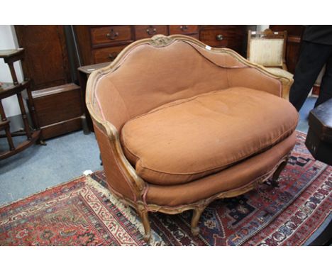 AN 18TH CENTURY FRENCH STYLE BEECH FRAMED SMALL SOFA, with floral carved decoration to the cresting rail and standing on shor