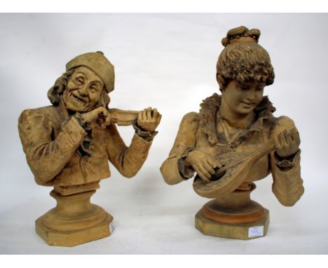 A PAIR OF CONTINENTAL HALF LENGTH PORTRAIT TERRACOTTA BUST depicting a young girl playing a mandolin and an old man playing a