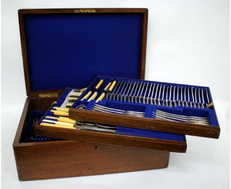 A WALKER AND HALL SHEFFIELD CANTEEN OF SILVER PLATED CUTLERY, all housed within an oak and brass mounted case, the box 47cm w
