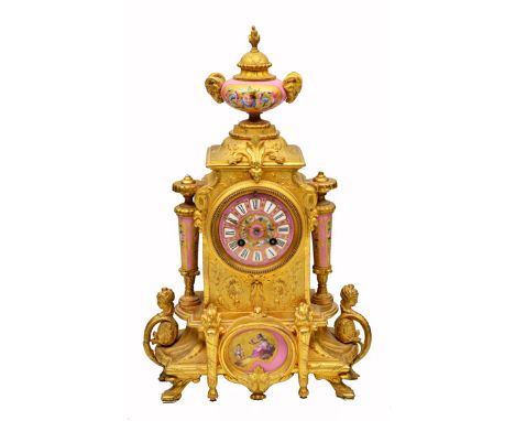 A LATE 19TH CENTURY FRENCH GILT METAL MANTLE CLOCK with pink porcelain mounts stamped P.H. Mourey to the back, 56cm wide 