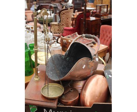 A COPPER COAL SCUTTLE together with lidded copper saucepan, a shallow kettle, a copper hot water bottle and a set of brass sc