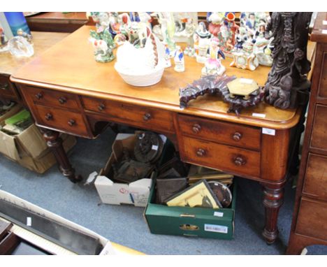 A VICTORIAN MAHOGANY KNEE HOLE WRITING TABLE with galleried back over an assortment of five various drawers, each with turned