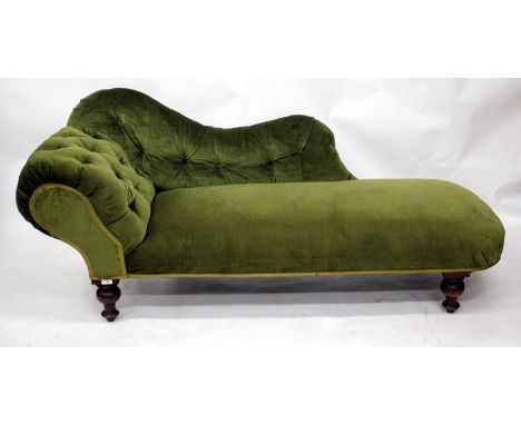 A VICTORIAN CHAISE LONGUE with a rolled end and on turned legs, upholstered in button green material 183cm long