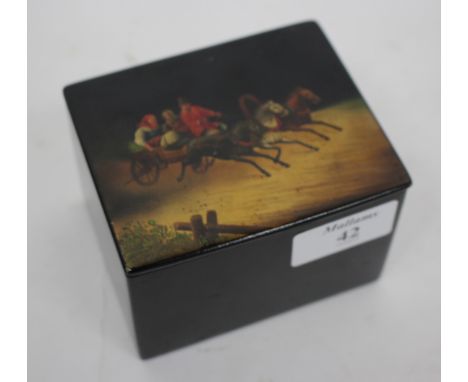 A RUSSIAN PAPIER MACHE TEA CADDY of rectangular form, the lid decorated with four figures within a horsedrawn cart, 9.8cm wid