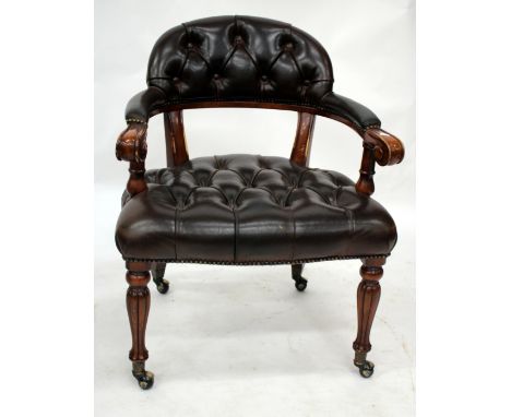 A MODERN LEATHER BUTTON UPHOLSTERED LIBRARY CHAIR with curving back and arms, overstuffed upholstered seat and turned taperin