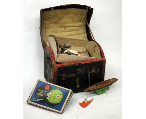 A DOME TOPPED LEATHER TRUNK (AF) together with a pond yacht and Chad Valley cricket game and a further green canvas trunk and