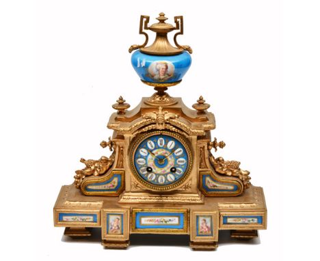 A 19TH CENTURY FRENCH GILT 8 DAY MANTLE CLOCK with blue enamelled dial and Roman numerals and having inset handpainted backs