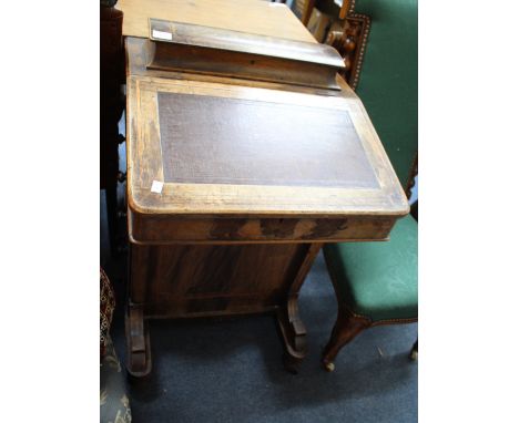 A VICTORIAN ROSEWOOD DAVENPORT DESK with pen box top, fall front and standing on turned feet and ceramic castors, 55cm wide 