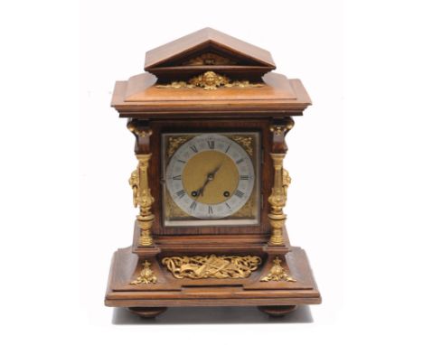 A LATE 19TH CENTURY OAK CASED MANTLE CLOCK with gilt metal mounts, the silvered dial with Roman numerals, overall 35cm wide x