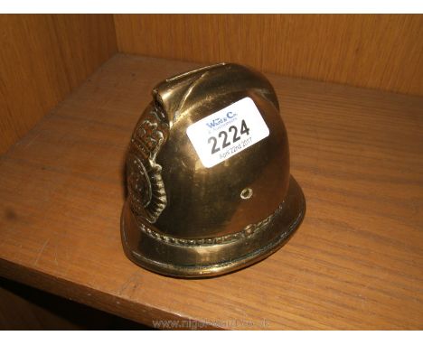 A Brass Money Box in the form of a Policeman's Helmet