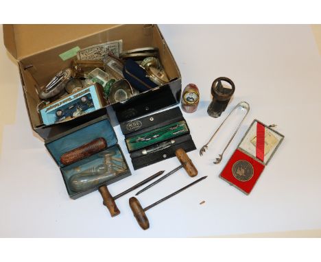 A box of collectable items including boxed, Matchbox vehicle, oval photo frame, tongs, drawing instruments, tuning fork, tabl