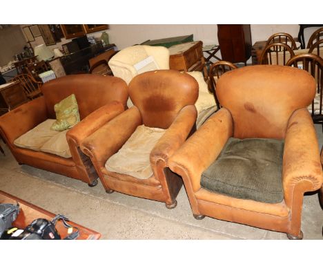 A brown leather club suite comprising of two seater sofa and two matching armchairs 