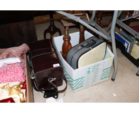 A box containing portable typewriter in carry case, turned wooden table lamps and a carry case