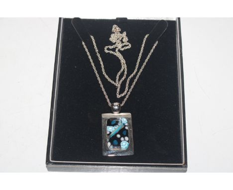 A pendant with Millefiori glass panel hung to white metal chain 