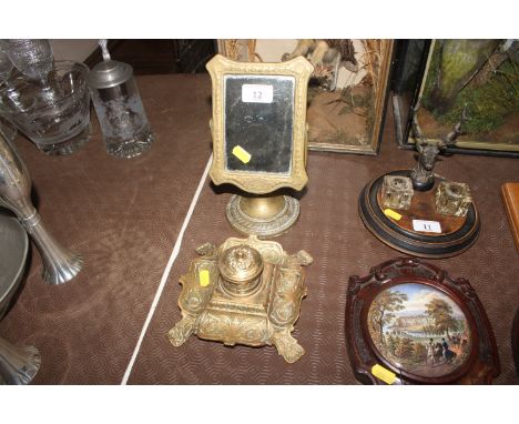 A brass swing frame mirror; and an ornate brass inkwell