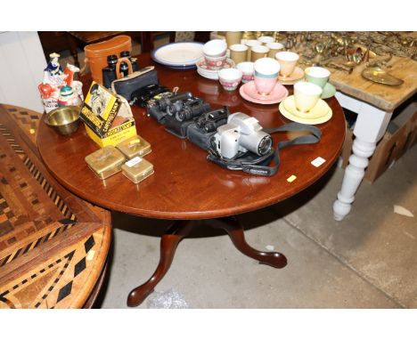 A mahogany circular topped table raised on tripod base