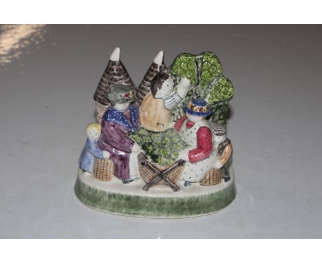 A Rye Pottery figure group "The Hop Pickers" marked to base Rye for L.H.L.