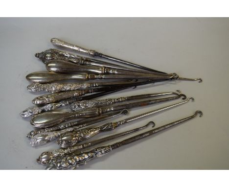 Fifteen various silver handled button hooks.