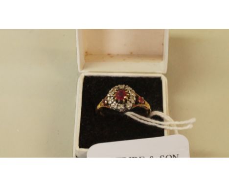 An 18ct gold ruby and diamond cluster ring, having ruby shoulders.