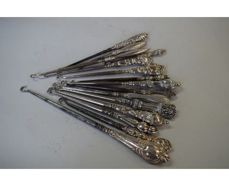 Fifteen various silver handled button hooks.