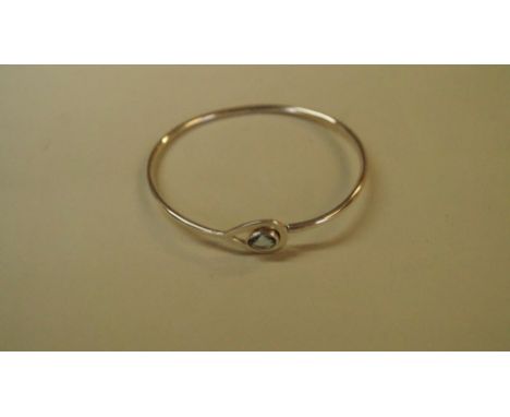 A modern silver gem set bangle.