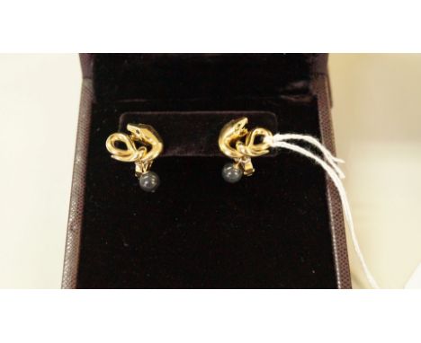 A boxed pair of Boucheron 'Trouble' 18ct gold and jade earrings, modeled as snake with attached jade bead, with original Bouc